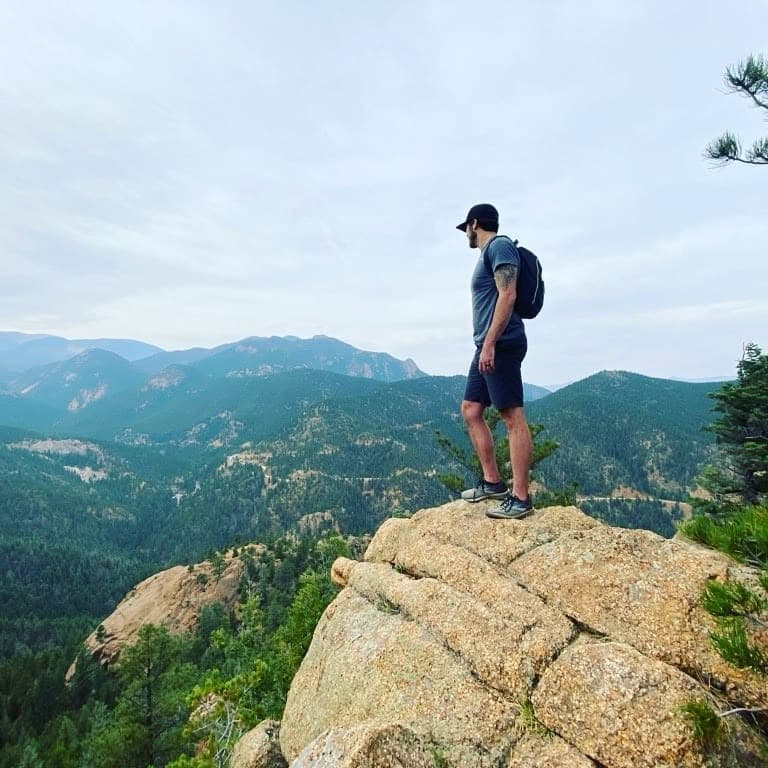 John Cravey, Founder of Frontend Horizon, on a ridge overlooking the mountains